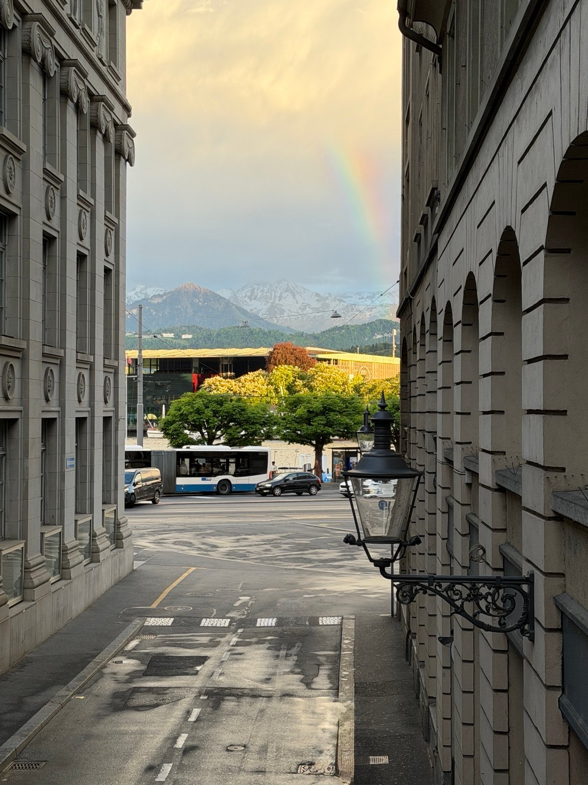 Rainbow and mountains framed by city architecture